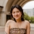 Celeste Chen stands in front of an archway and smiles for the camera