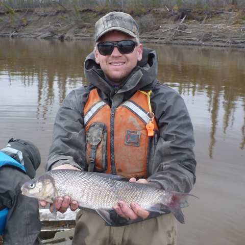 A person holds a fish