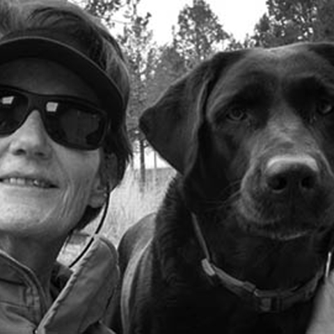 a black and white photo of a woman and a dog