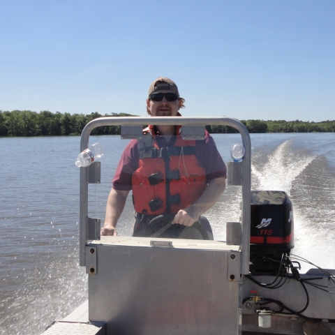 Josh driving a boat