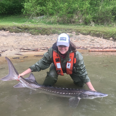 Paige holding a white sturgeon