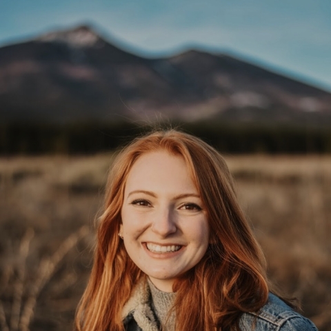 Service staff member, Lauren Sarantopulos, with mountains in the background