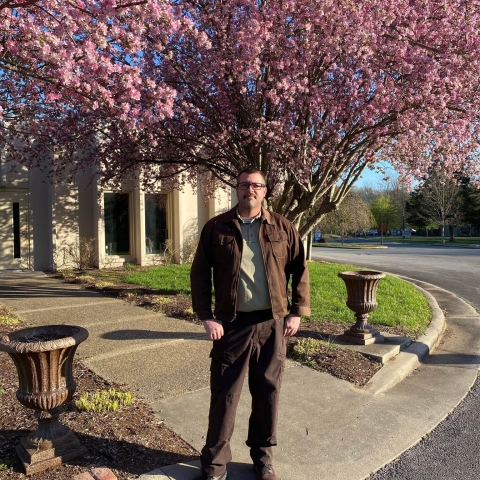 Deputy Project Leader Travis Collier in front of Hatchery building