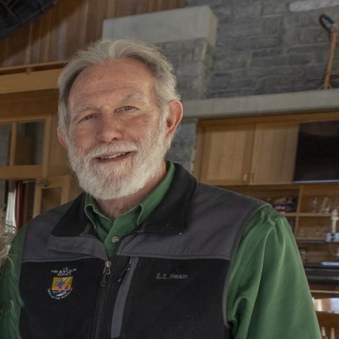 person with black vest with emblem of USFWS