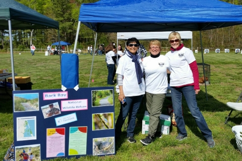 Volunteers staffing a table for Back Bay Refuge at a special event.