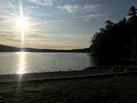 The sun rises above Craig Pond in Orland, Maine