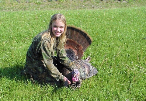 Youth turkey hunter with harvested turkey at Big Oaks NWR