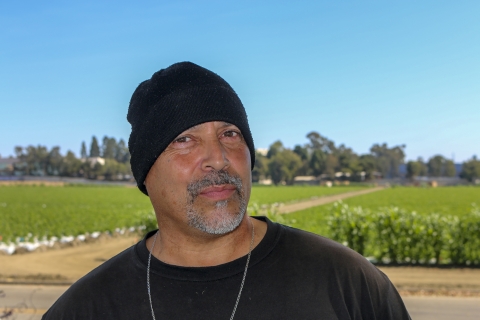 A man wearing a black beanie and black shirt