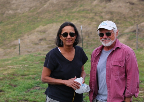 A man and a woman smiling at the camera