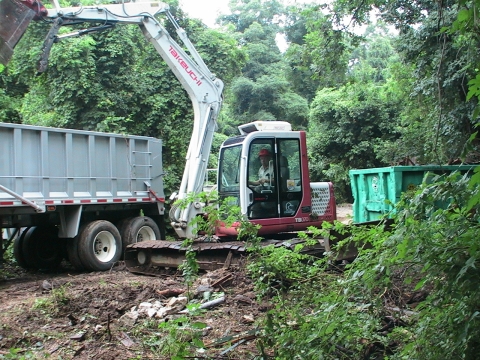 A piece of heavy equipment removes storm debris