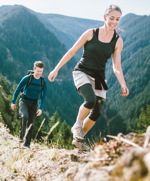 two people hiking atop a beautiful ridge. 