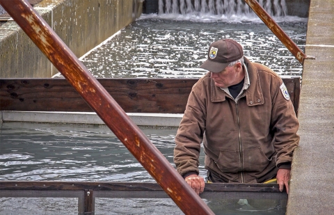 a man in a cement water tank with a screen