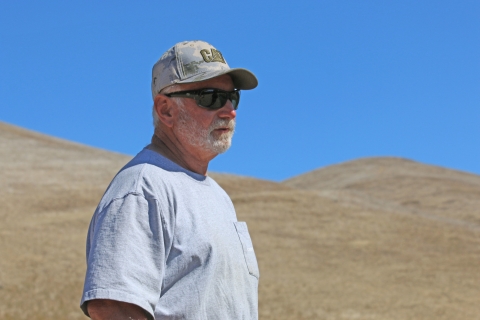 A man wearing a hat and sunglasses