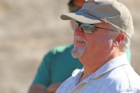 A man wearing a hat and sunglasses