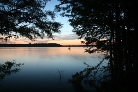 The sun setting over a lake.