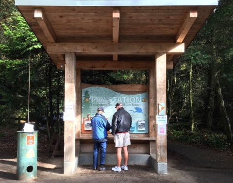 A Volunteer Assists a Visitor at the Entrance Station