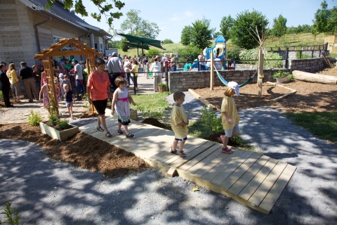 children playing on wooden bridge