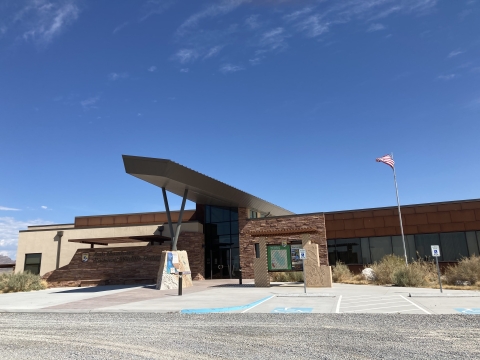 Visitor Center Building, American flying on the right and blue sky in the background