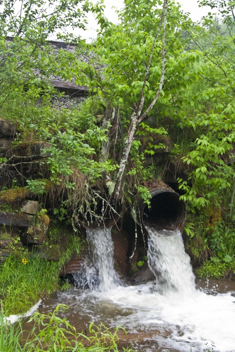 photo of culverts perched very high above stream bed, creating barrier to fish passage