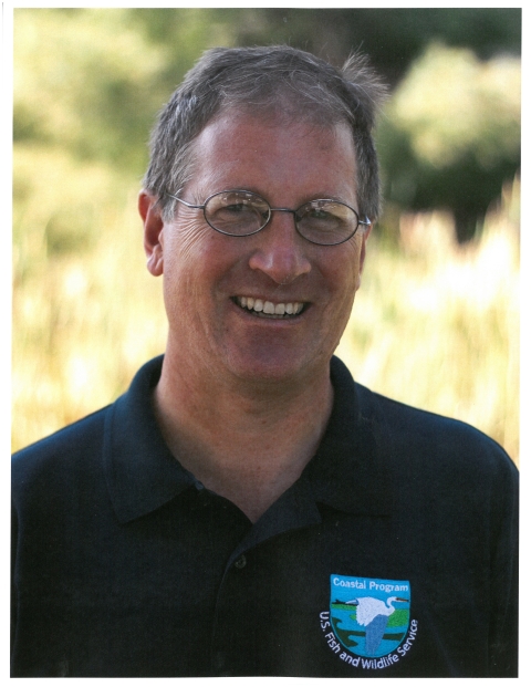 biologist portrait in front of vegetation