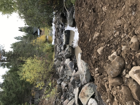 Partly dewatered stream with large boulders