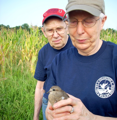 A woman and man who volunteer band doves at Santee NWR