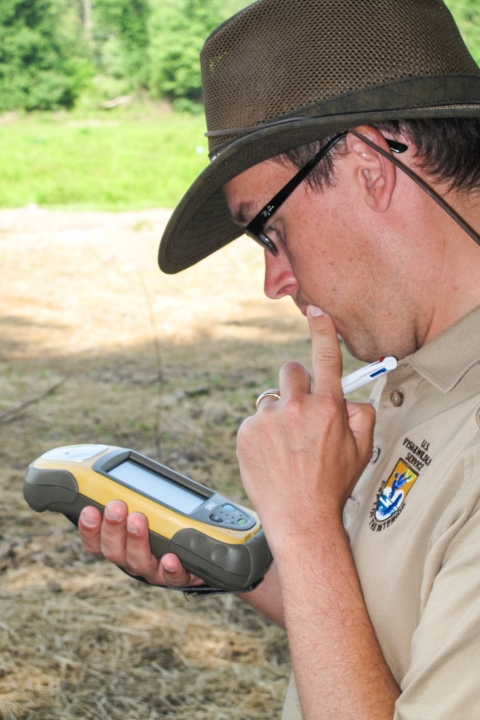 Person looking down at a global positioning service device