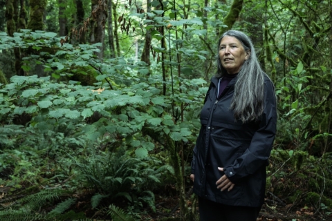 Judy Bluehorse Skelton standing in the forest