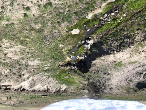 A stream canyon surrounded by steep cliffs