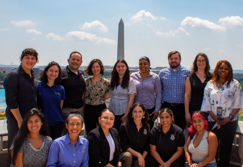 A group of people in formal attire standing in front of the Washington Monument in Washington D.C.