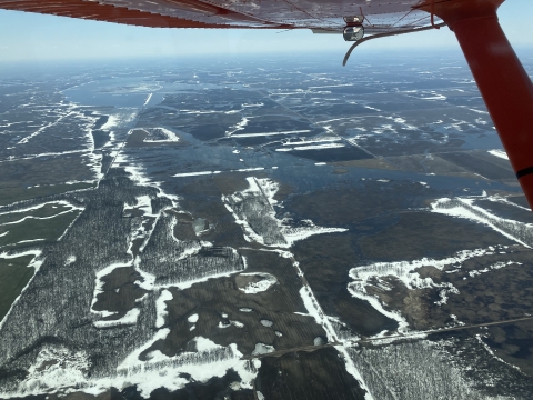 The view from an airplane showing show on the landscape