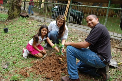 man, woman and girl plant