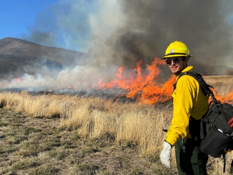 A FWS firefighter near a prescribed burn 