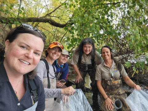 Five biologists at the Cape Fear River, NC prepare to release endangered fish