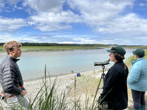 Conservation Fund and Pacific Birds Joint Venture staff stand on the banks of the Dinosaur Parcel on Alaska's Kasilof River. 