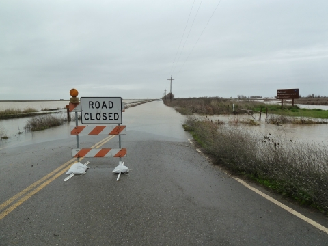 image of road closed sign on a flooded road