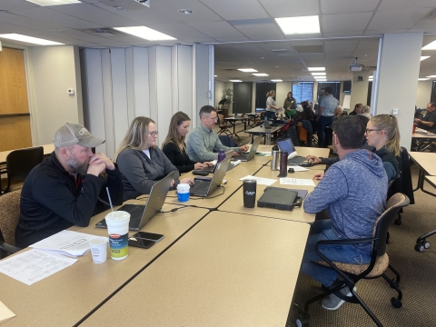 a group of people working together at a table