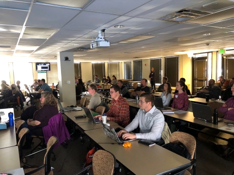 a group of people watching a presentation