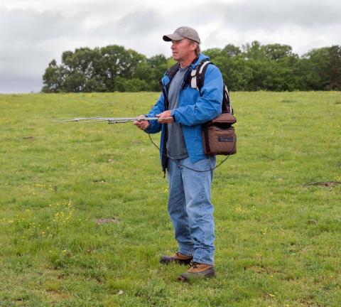 Volunteer Tom Ress holds radio telemetry equipment as he tracks cranes in Wheeler National Wildlife Refuge. 