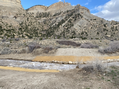 A free-flowing Price River with burlap along the banks