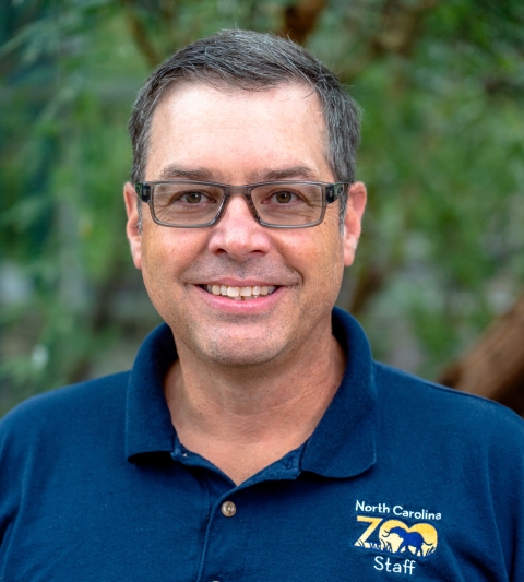 Portrait of person wearing North Carolina Zoo polo.