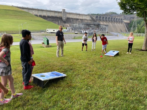 Kids playing cornhole