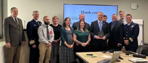 The 2022 Presidential Migratory Bird Federal Stewardship Award winners from the USCG Sector Delaware Bay project team pose for a picture with their award at the Councils meeting