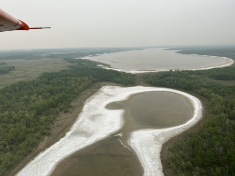 airplane view of the landscape partially filled with smoke