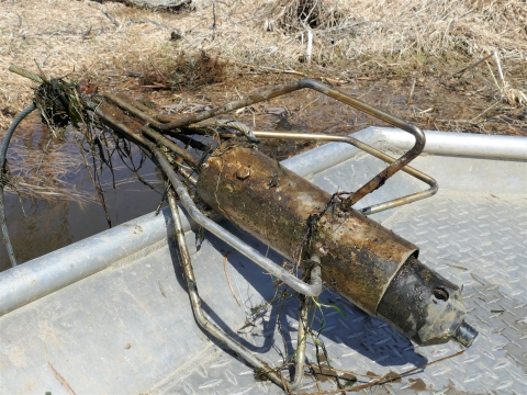 A muddy telemetry receiver sitting on a boat