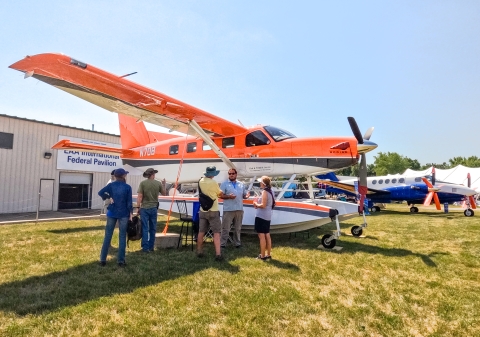 Migratory Bird Pilot Biologist Garret Wilkerson educating the public about aerial surveys and the Kodiak survey plane at EAA AirVenture event