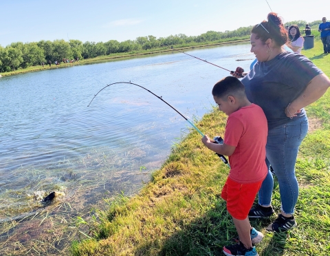 A person reeling in a fish. 