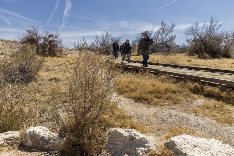 people walk on a boardwalk