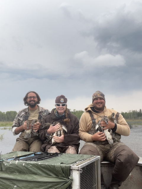 3 people holding ducks