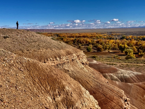 Man standing on top of clay bluff at Ouray NWR